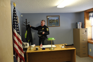 New Salem town police officer arriving at his desk