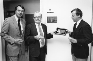 David C. Knapp inside presenting award to Andrew C. Knowles III with unidentified man