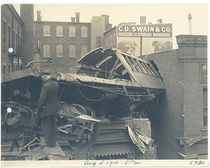 Wreck at Dudley Street, closeup of car lodged in building being dismantled