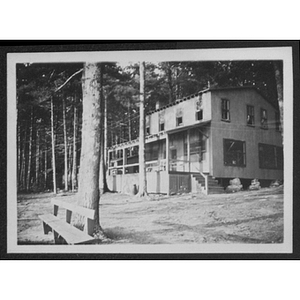 View of bench, building and trees at unidentified YMCA camp