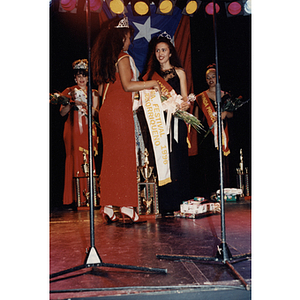 The 1995 Miss Festival Puertorriqueño Queen presents Yaritza Gonzalez with the Miss Festival Puertorriqueño 1996 sash