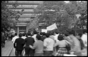 Antiwar demonstrators in serpentine dance with linked arms, downtown Tokyo