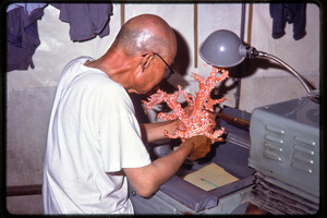 Arts and crafts factory: worker carving coral