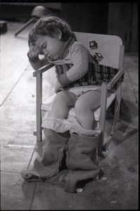 Child sleeping in a potty-training chair