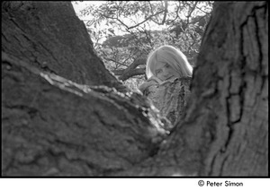 Karen Helberg posing over tree branch