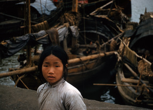 Young girl near fishing boats