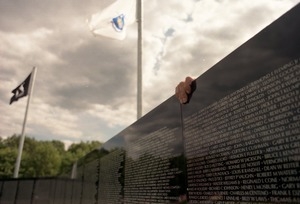 Hand reaching over the moving Vietnam War memorial