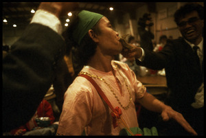 Cambodian New Year's celebration: drummer taking money in his teeth