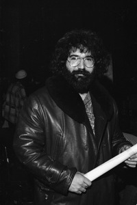 Grateful Dead performing at the Music Hall: Jerry Garcia backstage in a leather jacket and holding a rolled-up poster