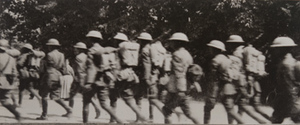 American soldiers marching along a tree-lined road