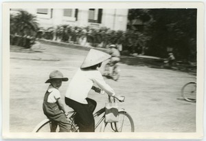 Mother and son on bicycle in French Quarter