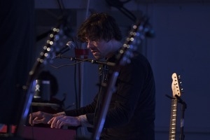 Matt Nakoa (keyboards) performing in concert at the Payomet Performing Arts Center, framed by Tom Rush's guitars