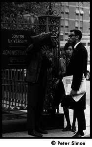 Umoja (Black student union) activists near sign for Boston University Administrative offices, during occupation of administration building (one man blocking camera with a briefcase)