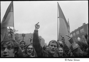 MIT war research demonstration: demonstrators raising their middle fingers and holding the NLF flag