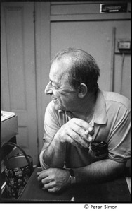 Fred Shibley (publisher of the Midtown Journal) laughing and smoking a cigarette