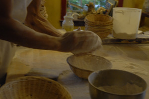 Hungry Ghost Bread: baker shaping loaves for baking