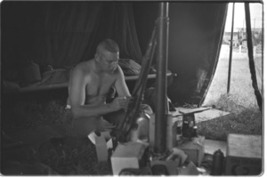 U.S. Officer eating combat ration in field tent.