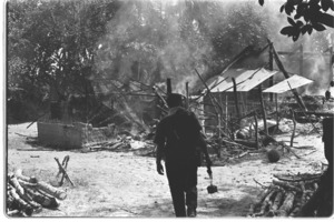 U.S. soldiers destroy huts in Vietcong-held village.