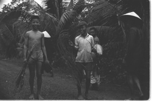 Children leaving village at dawn to go fishing in rice paddy; Luong Hoa Village.