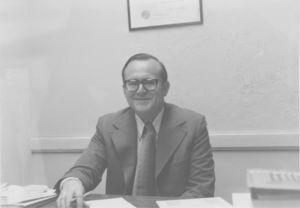Suffolk University Professor Bernard Meyler (SOM), seated behind desk