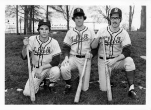 Suffolk University men's baseball players, kneeling and holding bats, 1972