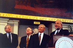 James Kelly, John Joseph Moakley (right, behind podium) and William M. Bulger (second from right) on the stage at Moakley's Silver Jubilee event at Faneuil Hall