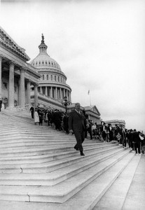 Thomas P. O'Neill walking down steps of U.S. Capitol, crowd in background