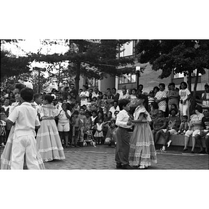 Children dance in pairs before a crowd of spectators at the Festival Betances.