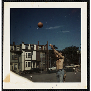 A man shooting a basketball in the South Boston Boys' Club playground