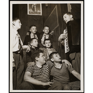 The Bunker Hillbillies pose on stairs with an unidentified man playing an accordion