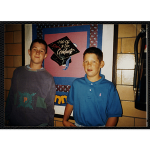 Two boys standing in front of a posterboard at the Edwards School
