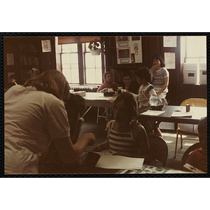 A Teacher talking to a student about her science fair project