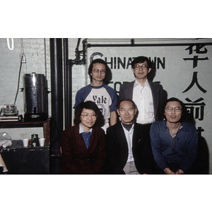 Suzanne Lee and Henry Wong with three other members of the Chinese Progressive Association in front of the organization's sign at their office