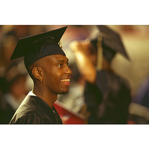 A Northeastern student in his cap and gown at commencement