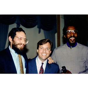 Two unidentified men and sportscaster Bob Costas