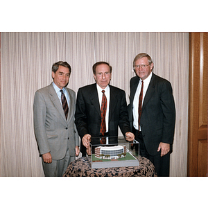 Neal Finnegan, Robert Shillman, and Richard Freeland stand behind a model of Shillman Hall