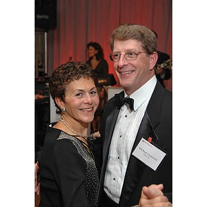 Alumnus Michael Crawford dancing with a guest at a dinner honoring members of the Huntington Society