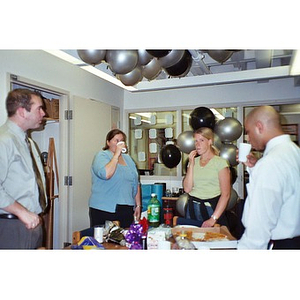 Four Northeastern University staff members at an office party