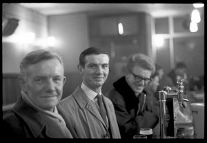 Three men drinking at the bar in a Scottish pub