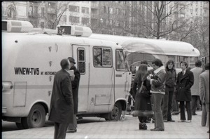 People milling alongside the Channel 5 news van