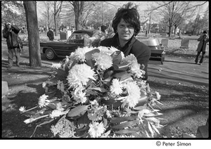 Jack Kerouac's funeral: Gregory Corso holding flowers at the cemetery, Allen Ginsberg filming in background