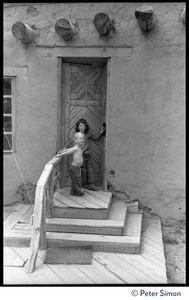 Children playing on the steps into a building at the Lama Foundation