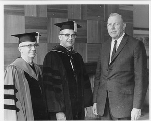 John W. Lederle in academic regalia with two unidentified men