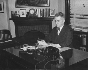 Hugh P. Baker sitting in his South College office