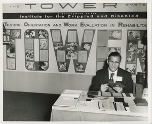 Jack Trapp at desk in front of ICD exhibit on the Tower System