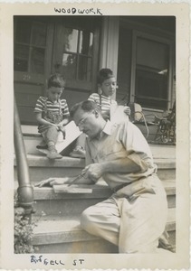 Paul Kahn with sons Joel and Paul on front stairs of house