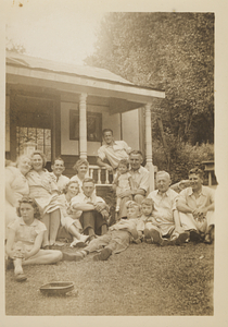 Group of people in front of house