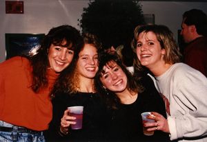 A group of Suffolk University students celebrate at a holiday party, 1990