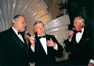 John Joseph Moakley (left), William Bulger (center, holding microphone) and unidentified man (right, holding microphone), singing at Moakley's Silver Jubilee event
