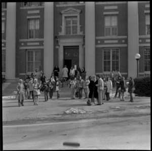 Photographs of students boarding Five College buses, 1973 April